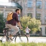 student on a bike riding to class